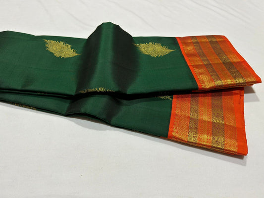 Bottle green with orange korvai with peacock feather buttas