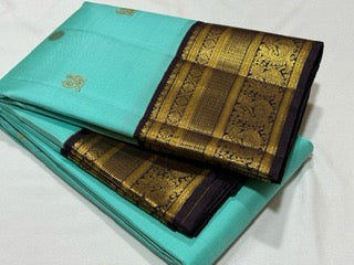 Aqua blue with dark brown mayil chakram buttas korvai