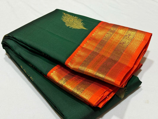 Bottle green with orange korvai with peacock feather buttas