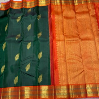 Bottle green with orange korvai with peacock feather buttas